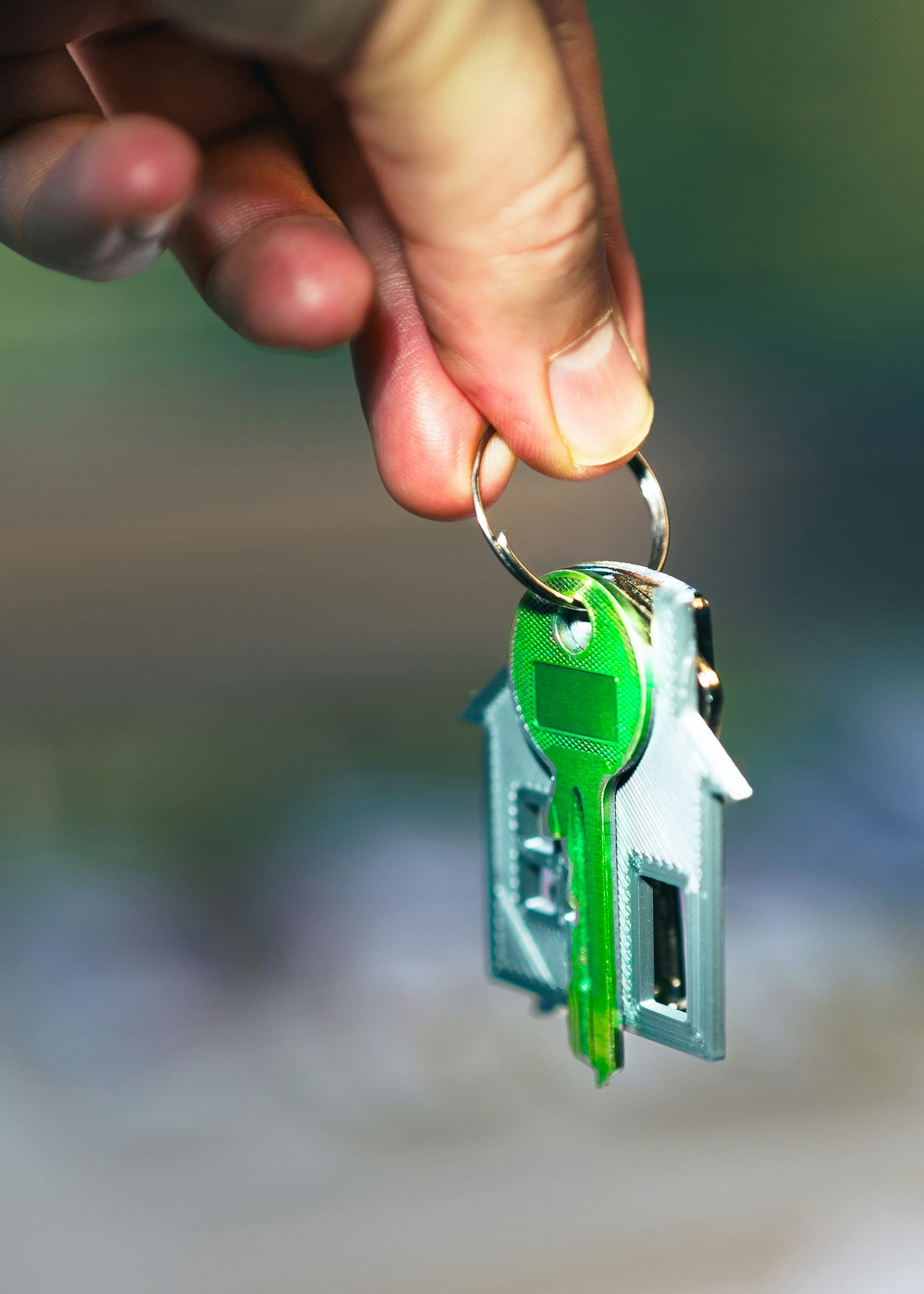Hand holding house key
